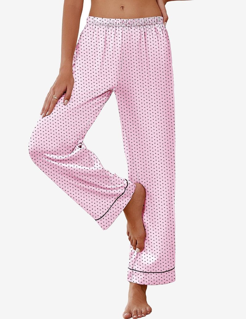 Pink satin pajama pants with small dotted pattern, elastic waist, and dark piping.
