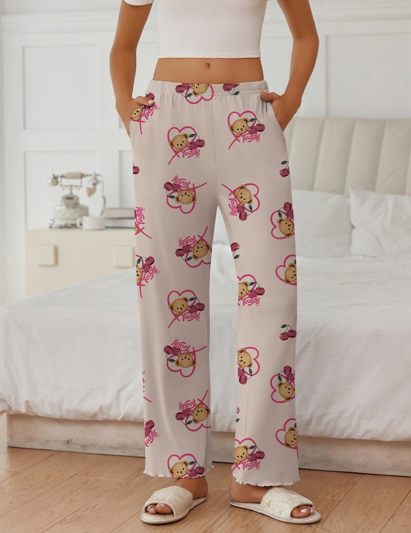 Pink teddy sleep pants in white with scattered heart-and-bear print, full length