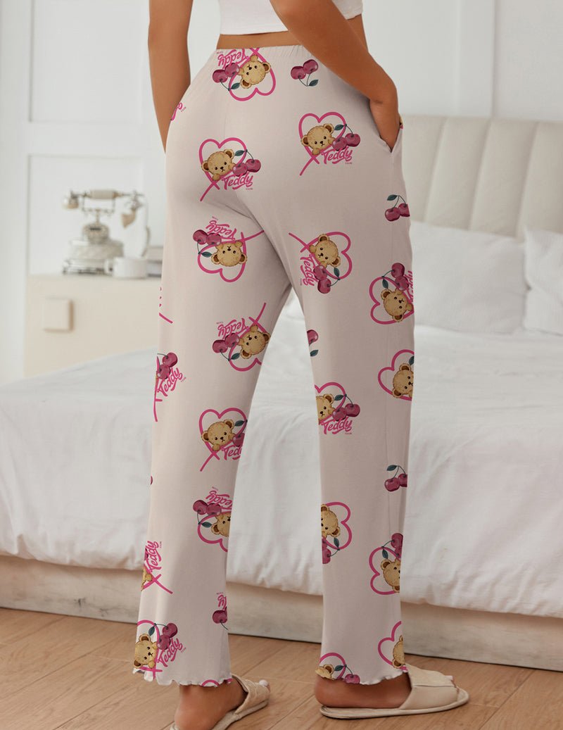 White teddy lounge pants with pink bows and bear faces all over, relaxed fit