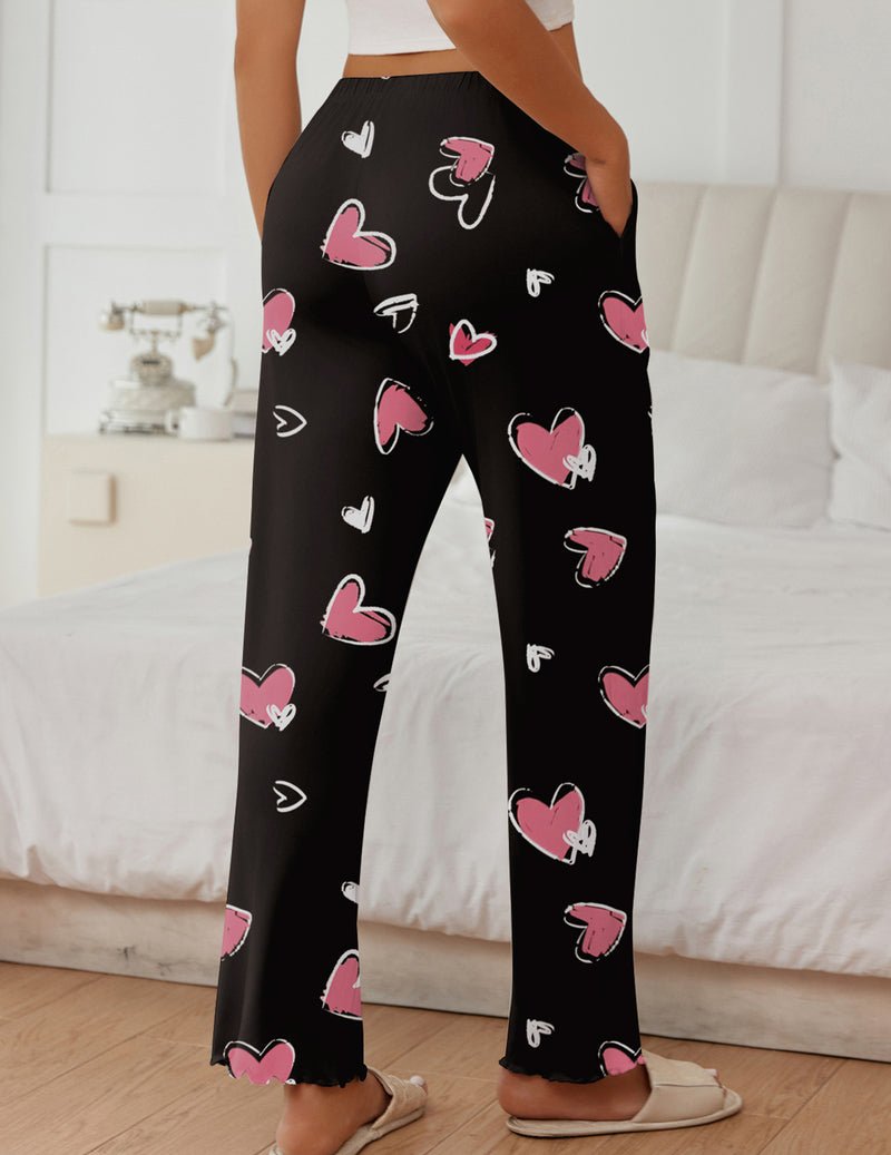 Black lounge sleep pants with pink heart and doodle pattern, wide straight legs