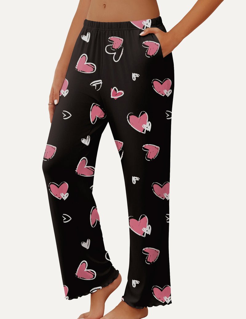 Black pajama pants with pink and white heart doodle print, elastic waistband
