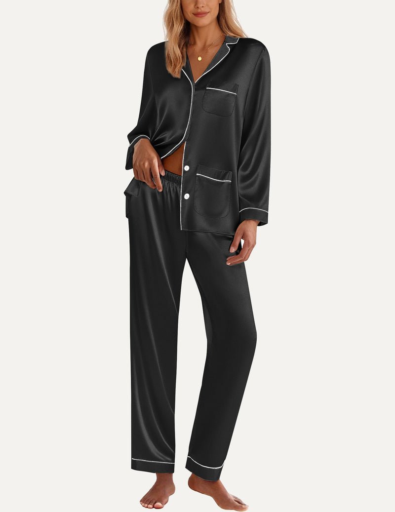 Black satin pajama set with button-front top, chest pocket, and long pants with trim