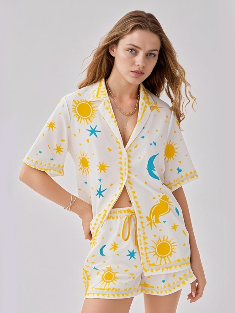 White sun and star print pajama set with short-sleeve button shirt and matching shorts
