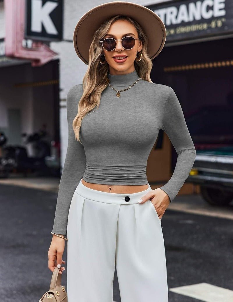 Dark gray long-sleeve turtleneck thermal top, fitted with ruched waist detail.