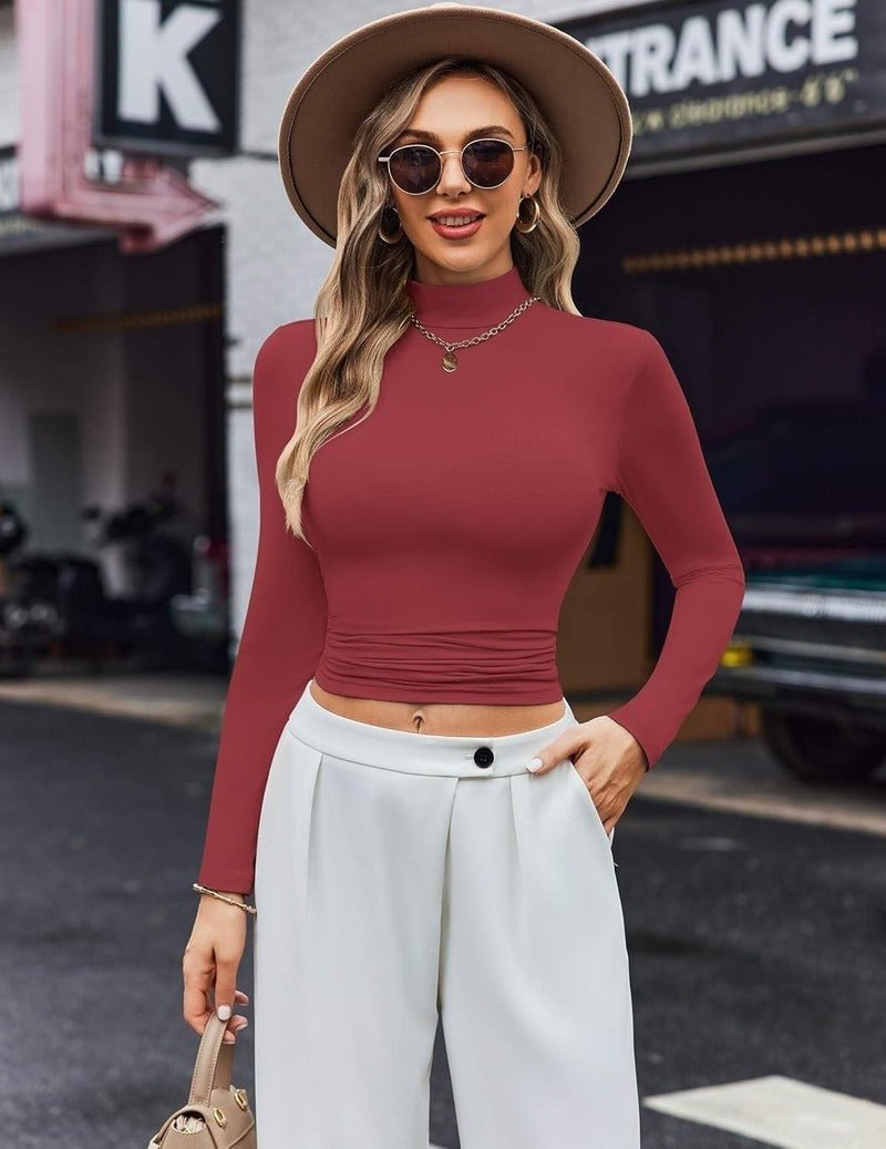 Red long-sleeve turtleneck top with high neckline and ruched midsection