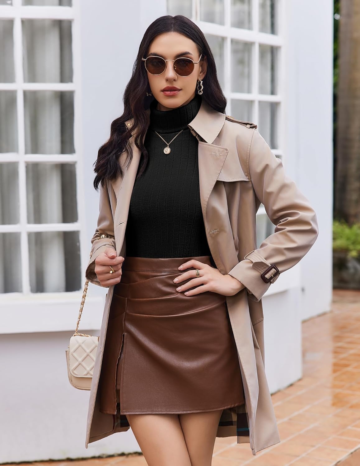 Black ribbed turtleneck long-sleeve top, front view with beige coat
