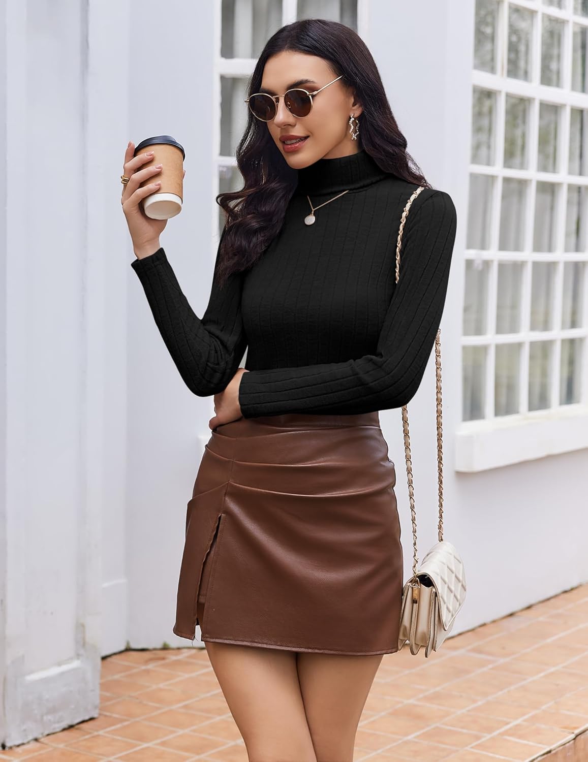 Black ribbed turtleneck long-sleeve top, front pose with arms crossed