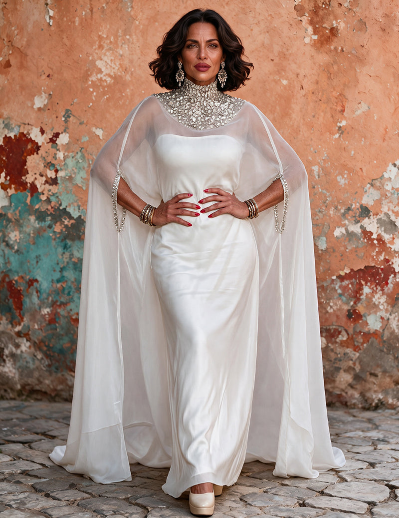 White high-neck beaded satin gown with sheer draped cape