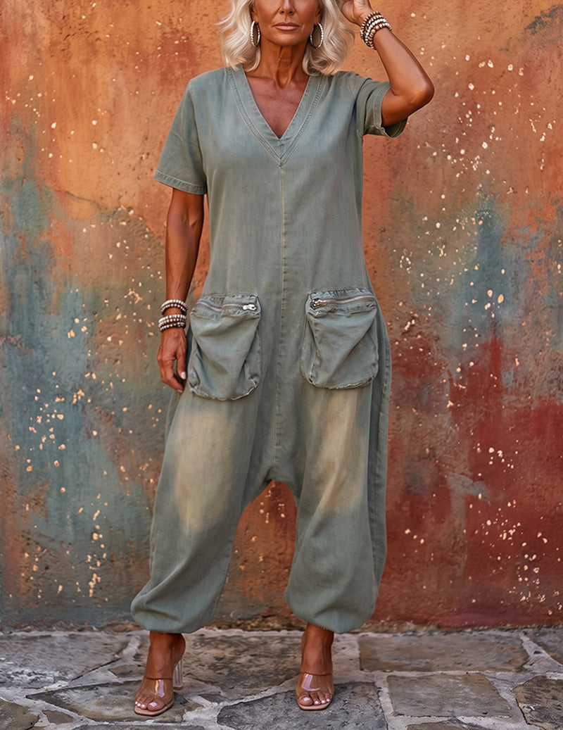 Full-length light blue denim V-neck cargo jumpsuit with wide legs and flap chest pockets