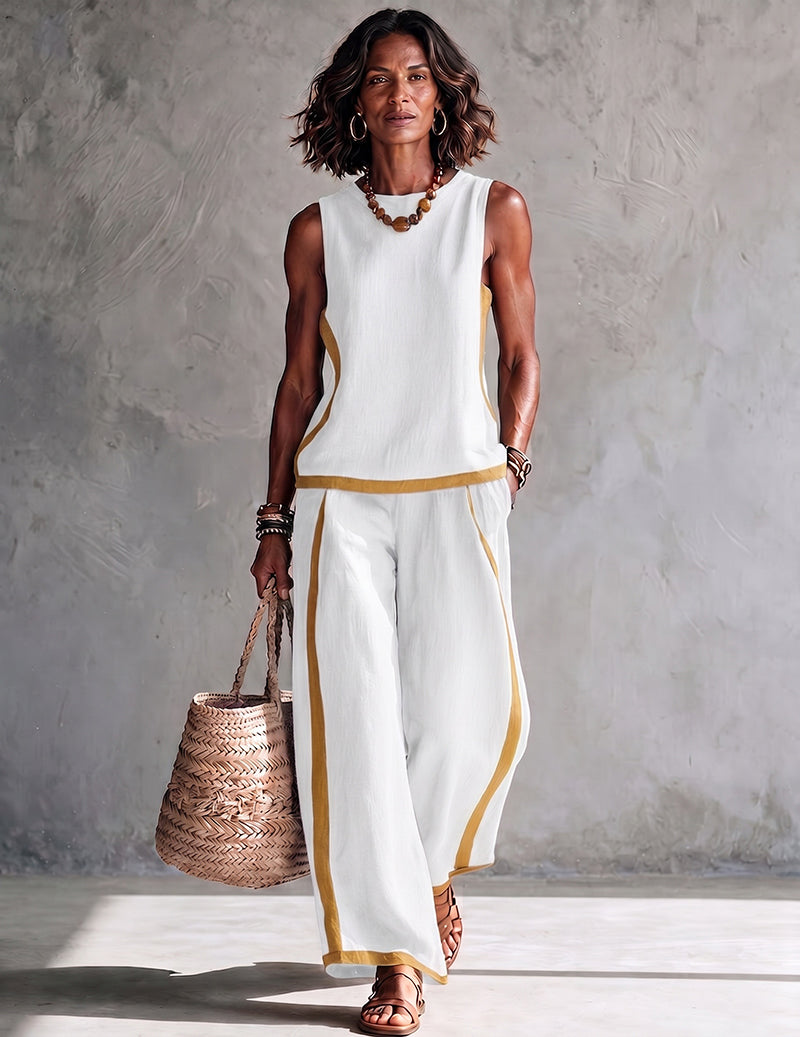 White sleeveless top and wide-leg pants set with gold contrast trim along edges