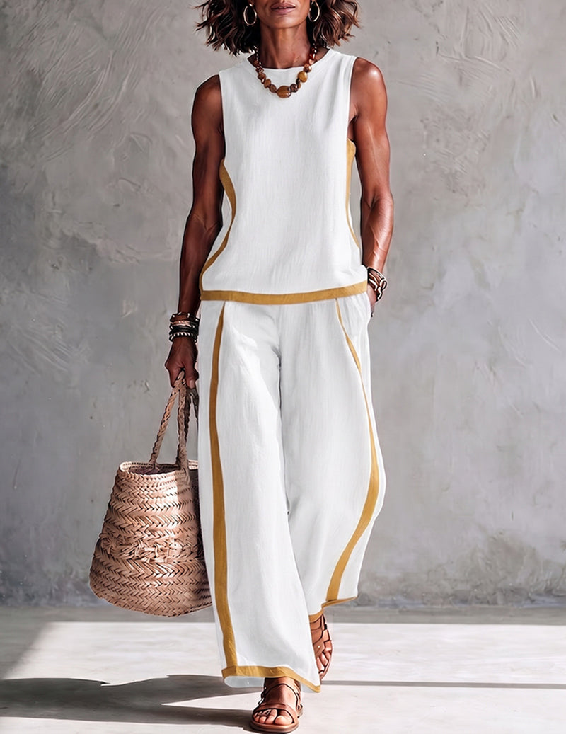 White sleeveless top and wide-leg pants set with gold trim at hem and side seams