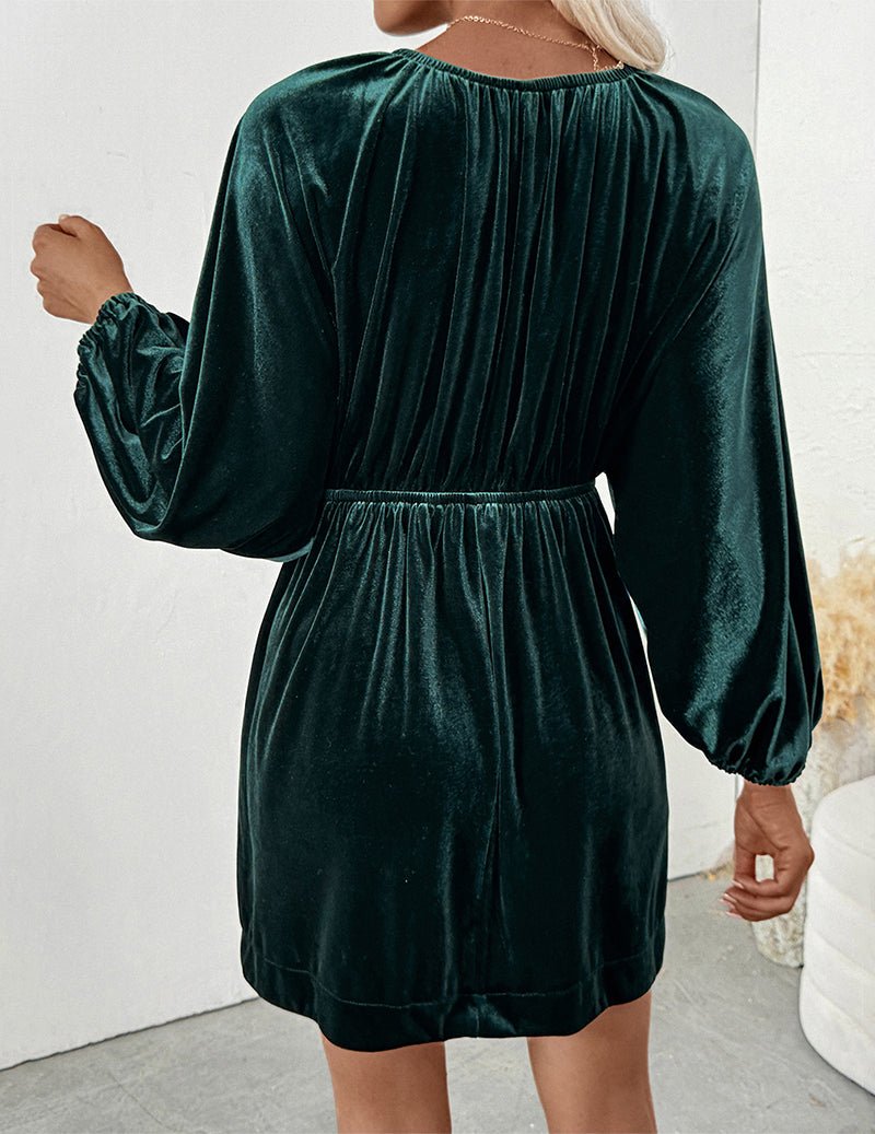 Back view dark green velvet mini dress with gathered waist and 3/4 sleeves