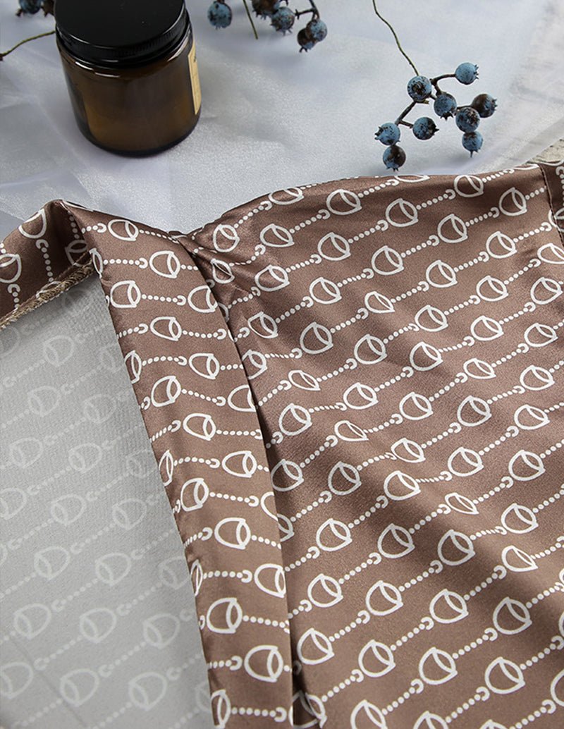 Brown fabric with white chain-link print, folded with edges visible