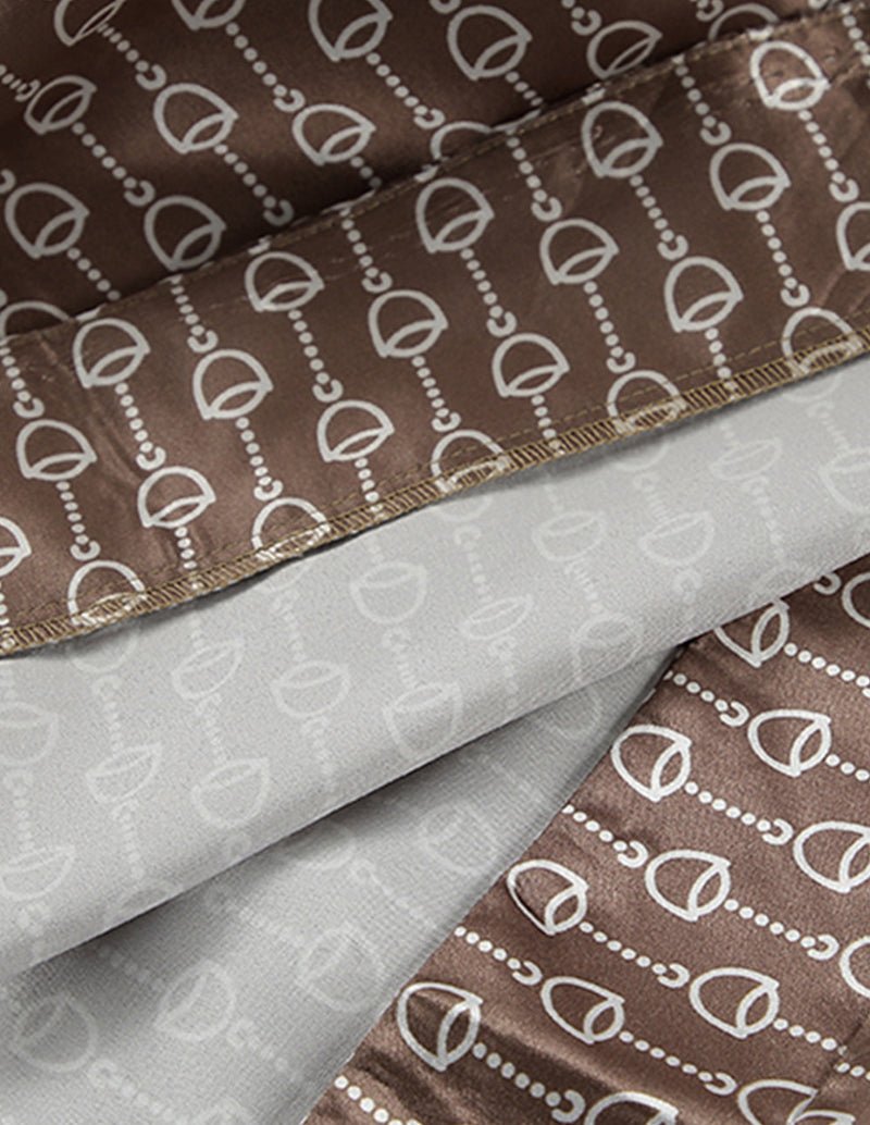 Brown fabric with white chain-link pattern and gold-toned trim edge