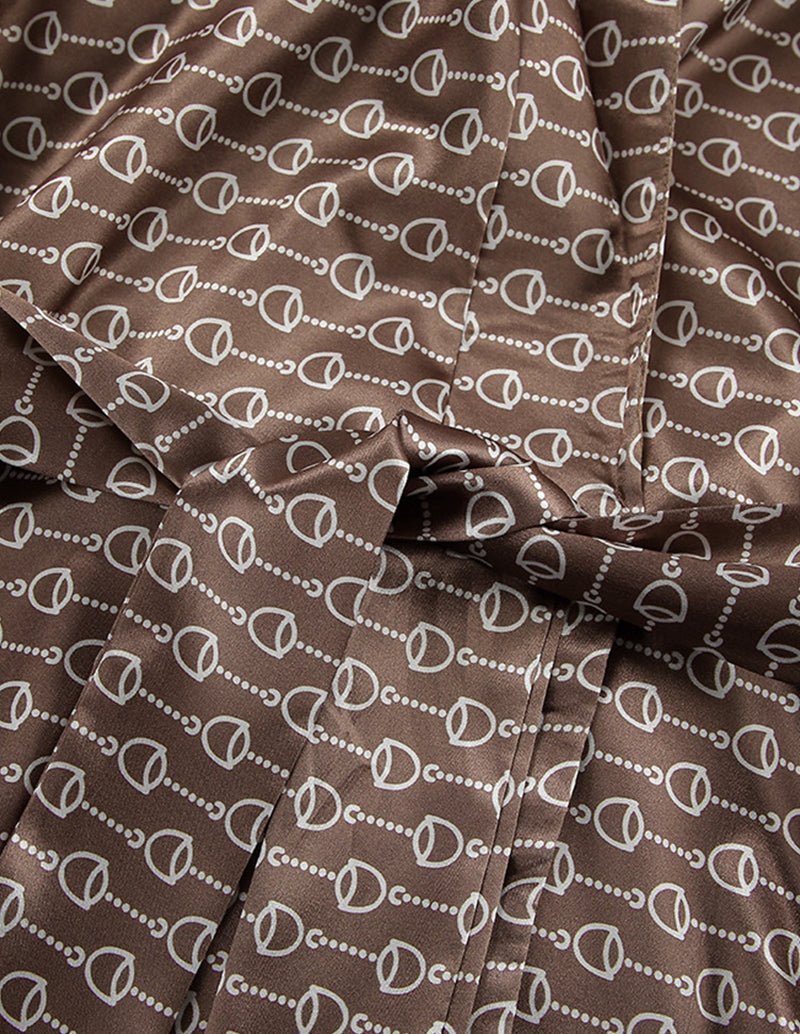 Brown fabric swatch with repeating white chain-link pattern and soft drape