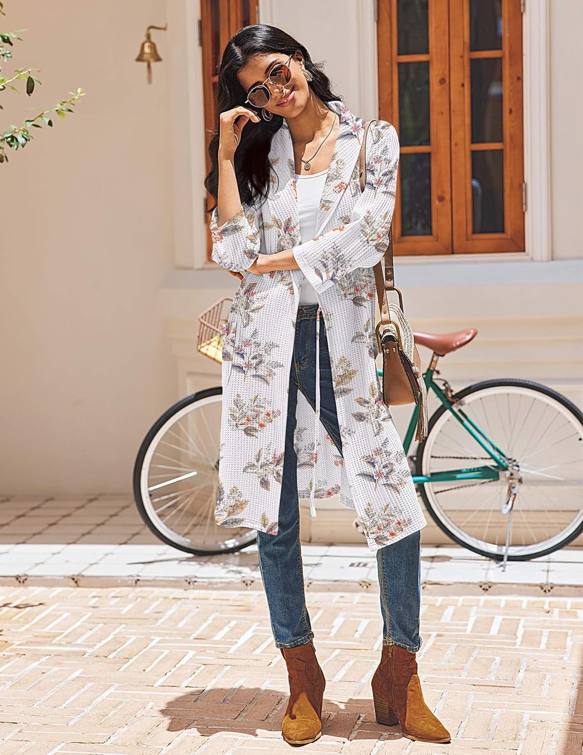 Waffle knit bathrobe with white floral print, kimono collar, tied belt and front pockets.