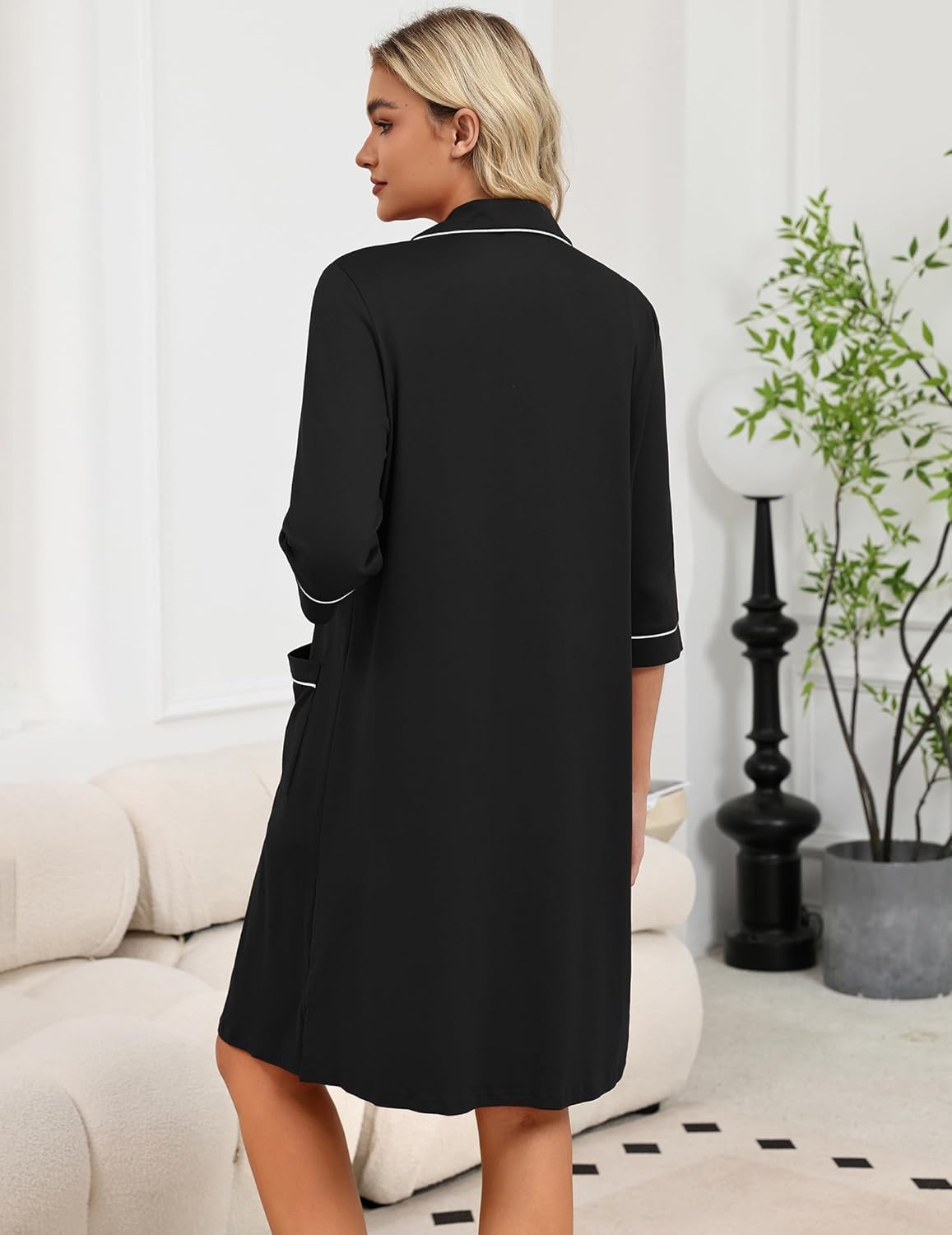 Black robe back view with 3/4 sleeves, front zipper line and contrast cuff trim.