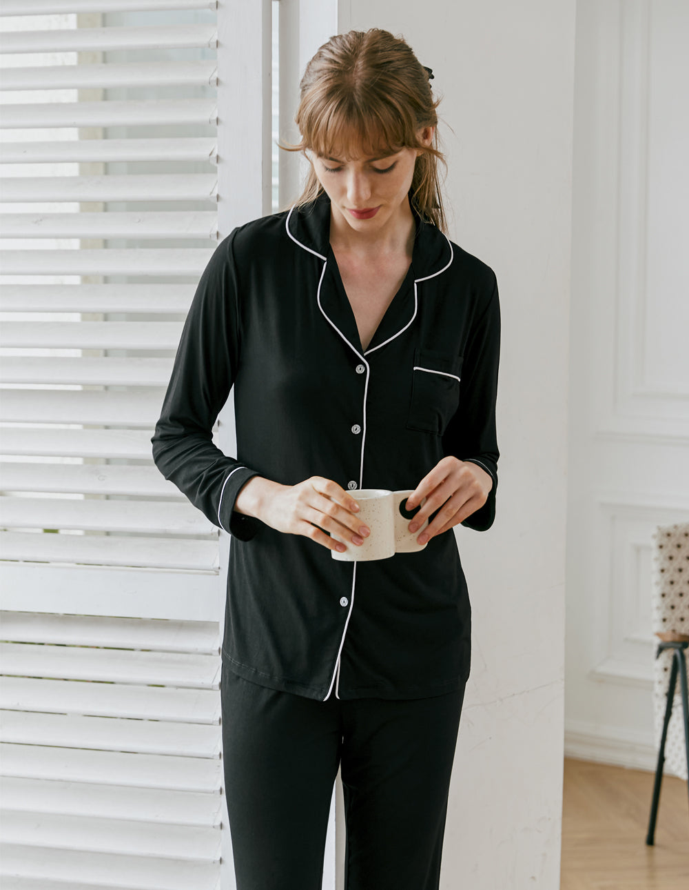 Black long-sleeve button pajama top with contrast piping and matching long pants