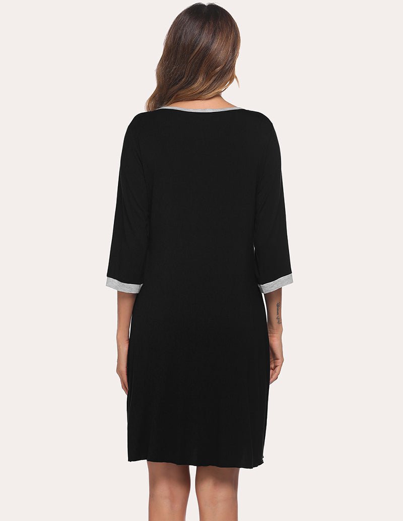 Black pleated nightdress with 3/4 sleeves, back view and white-trim cuffs