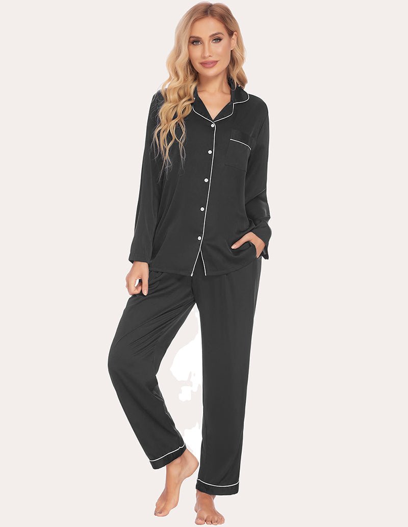 Black satin pajama set with contrast piping; button-up top and tapered cuffed pants