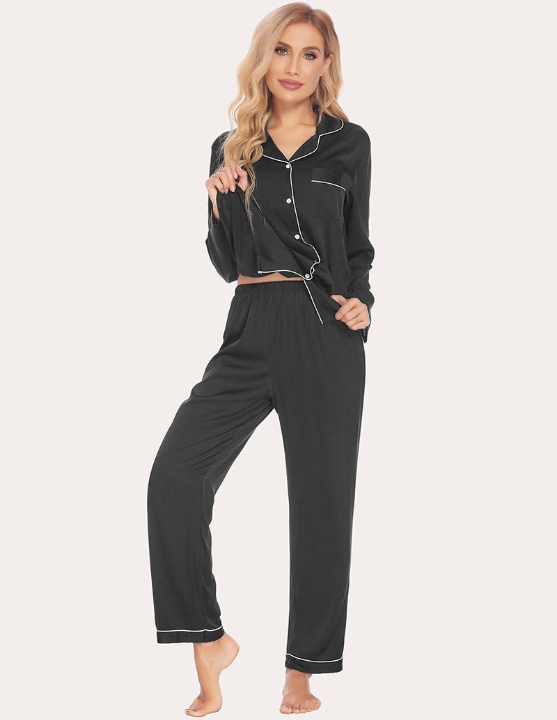 Black satin pajama set with contrast trim; long-sleeve top and relaxed cuffed pants