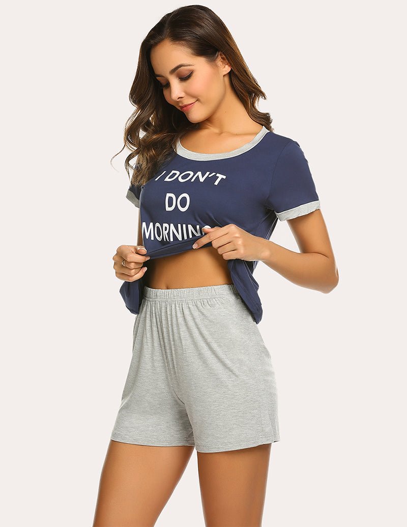 Navy letter-print pajama top lifting to show gray sleep shorts with elastic waistband