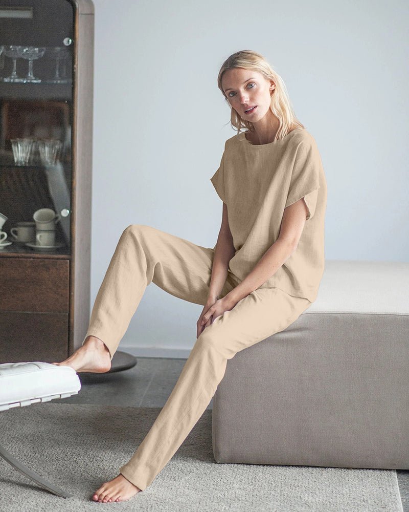 Beige cotton-linen pajama set, short-sleeve top and drawstring pants, seated view