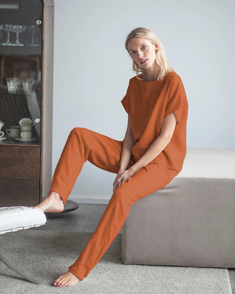 Orange cotton-linen pajama set, short-sleeve top and drawstring pants, seated view
