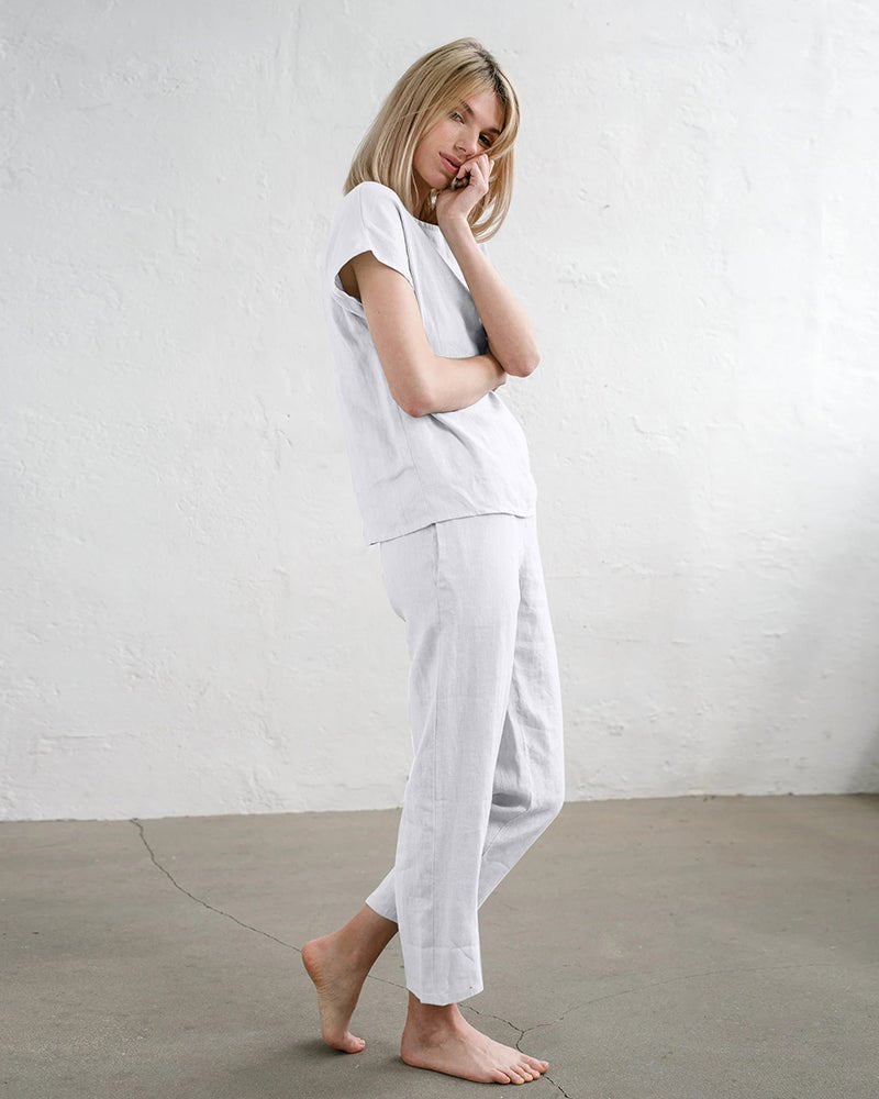 White short-sleeve pajama top and ankle-length drawstring pants, side view
