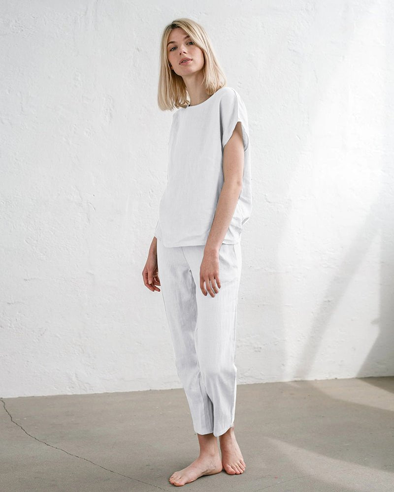 White pajama set with short sleeves and drawstring waist, full-length pants
