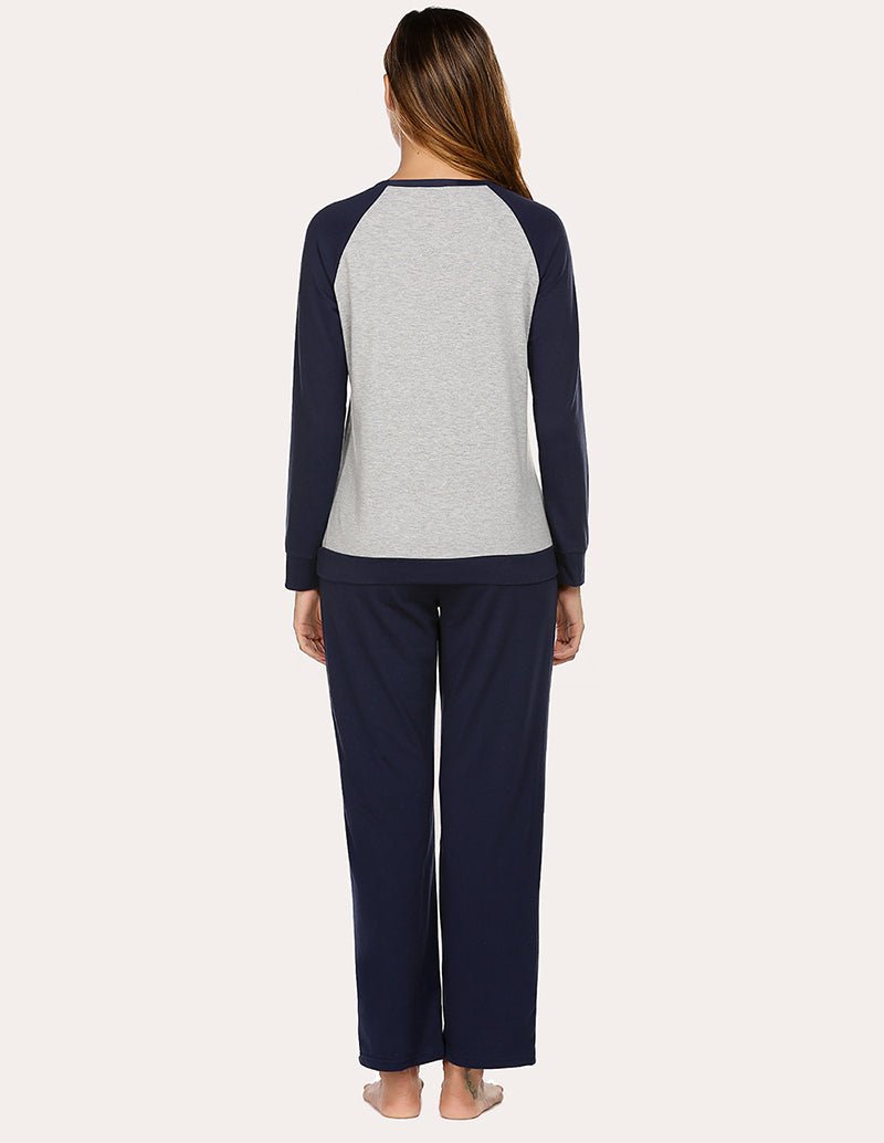 Women’s cotton pajama set from back view: heather-gray raglan top and navy pants