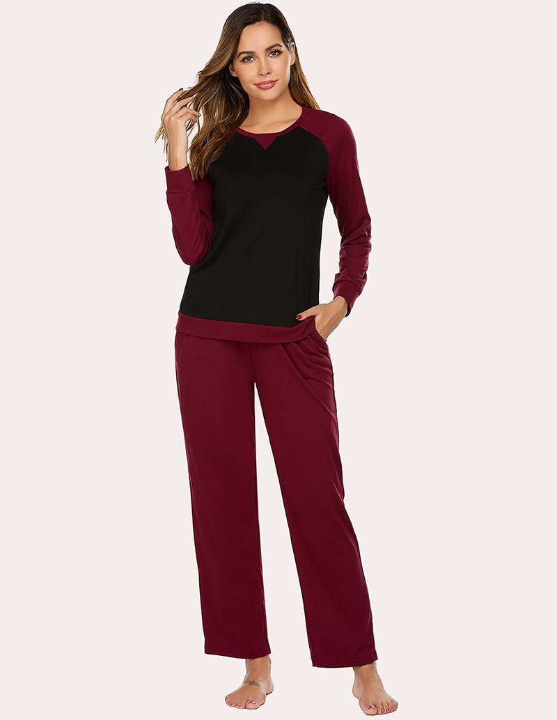 Cotton pajama set: long-sleeve raglan top and relaxed drawstring pants in wine red and dark.