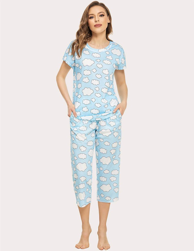 Cropped pajama set in light blue with white cloud print; short-sleeve top and capri pants.