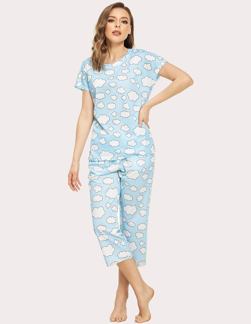 Cropped pajama set in light blue with white cloud print; three-quarter front view, capri pants set.