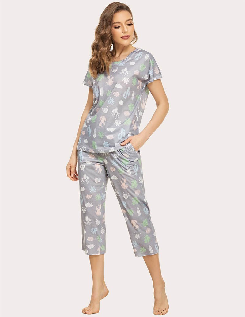 Cropped pajama set in grey with multicolor animal print; short-sleeve top and capri pants, standing.