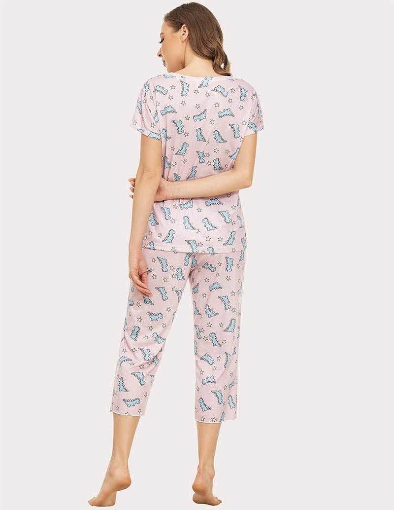 Women’s cropped pajama set, back view; light pink with blue dinosaur print, capri pants
