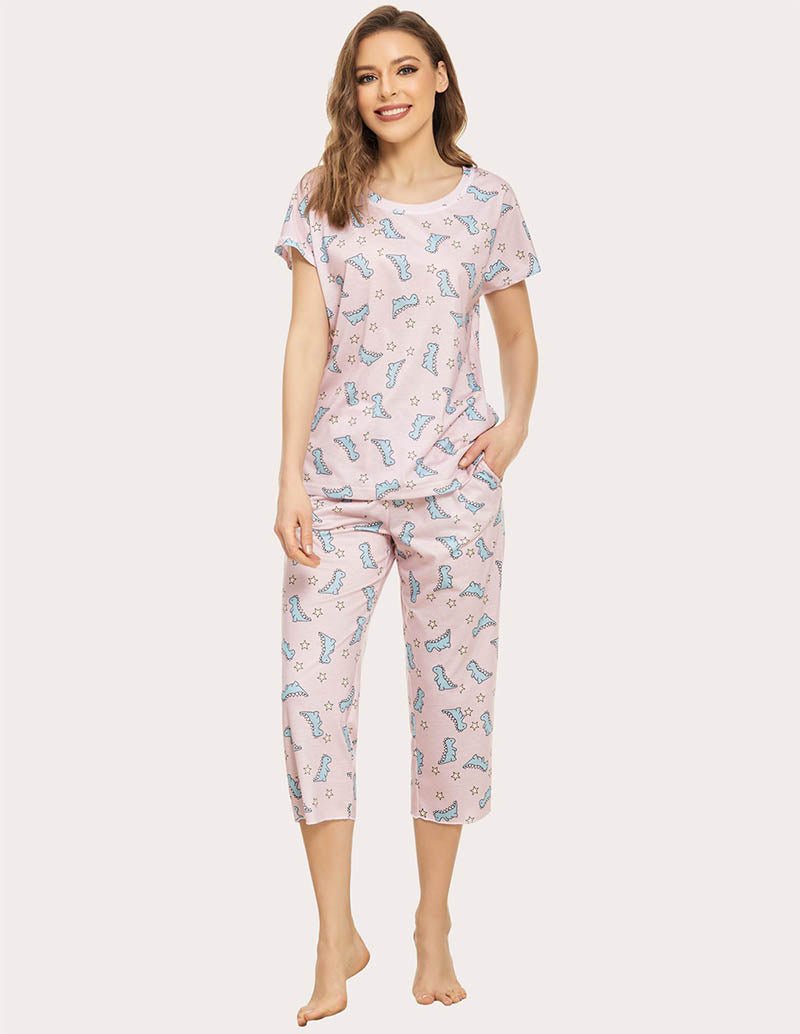 Women’s cropped pajama set in light pink with blue dinosaur print, short-sleeve top and capris