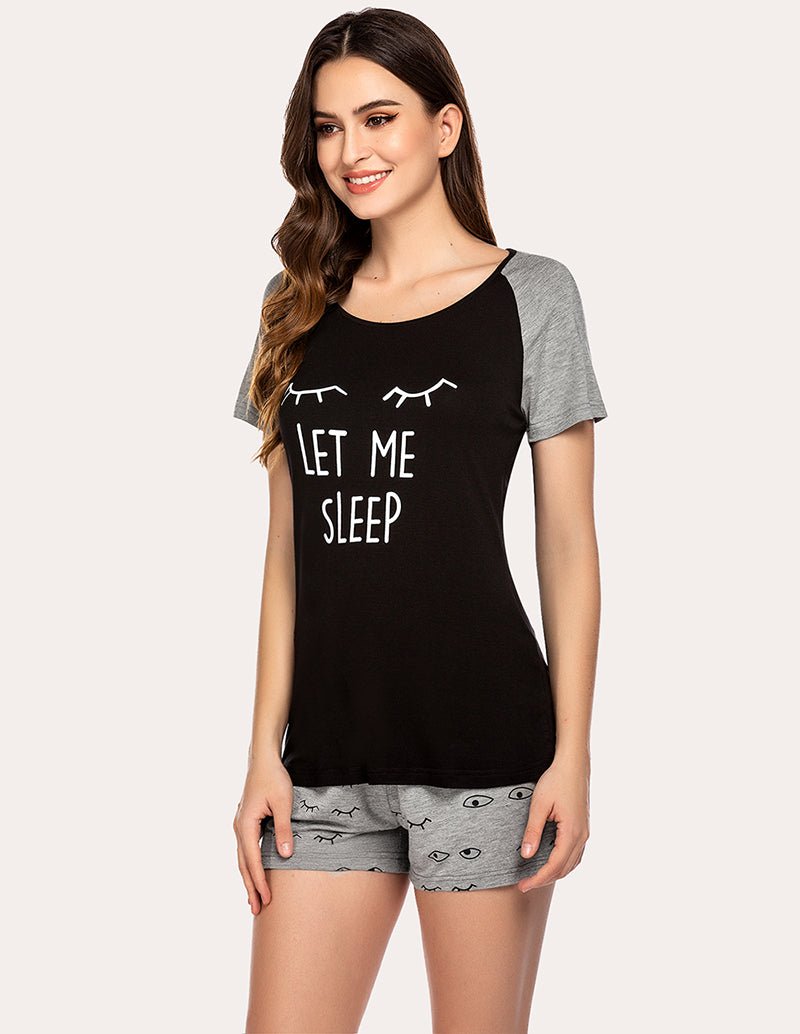 Women's black pajama set with 'Let Me Sleep' graphic top and gray sleep-print shorts