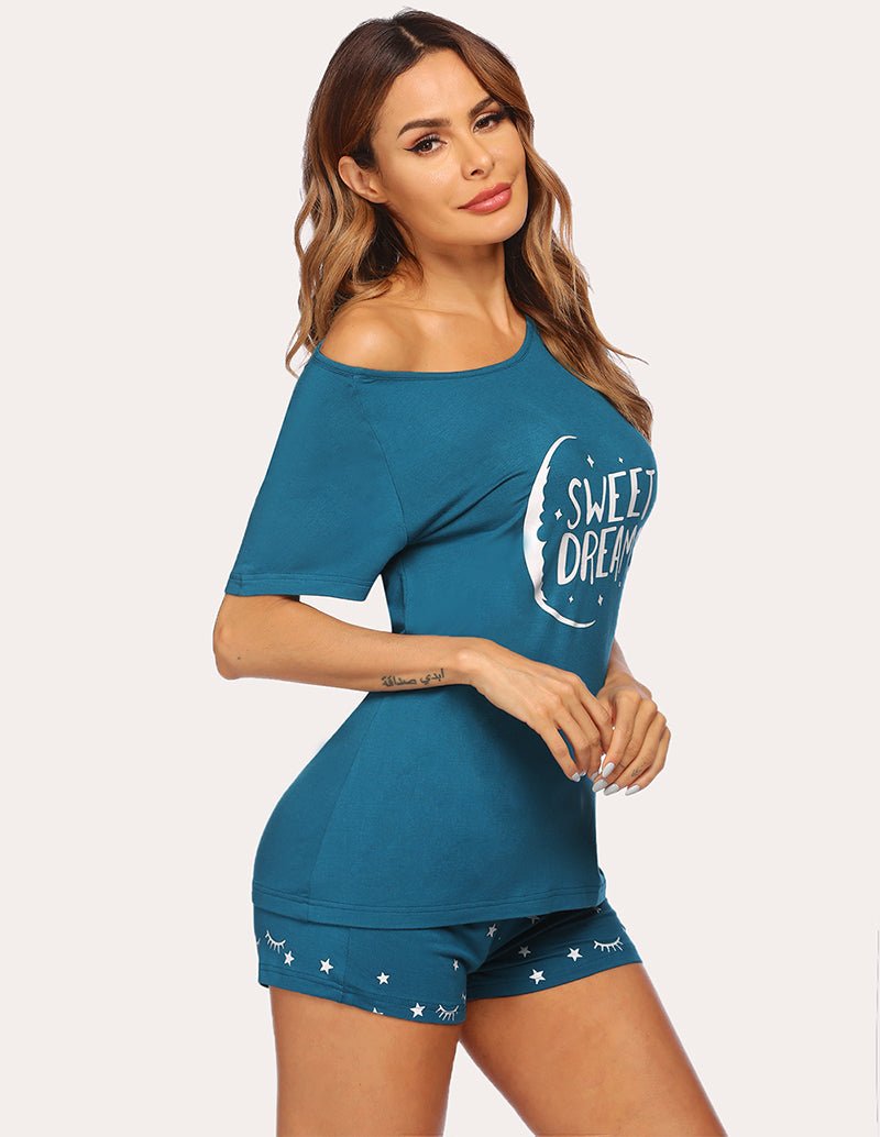 Women's peacock blue pajama set with 'Sweet Dreams' graphic top and patterned shorts