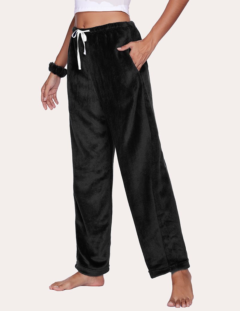 Black pajama pants front view: tie waist, slouchy flannel fabric, cuffed hem