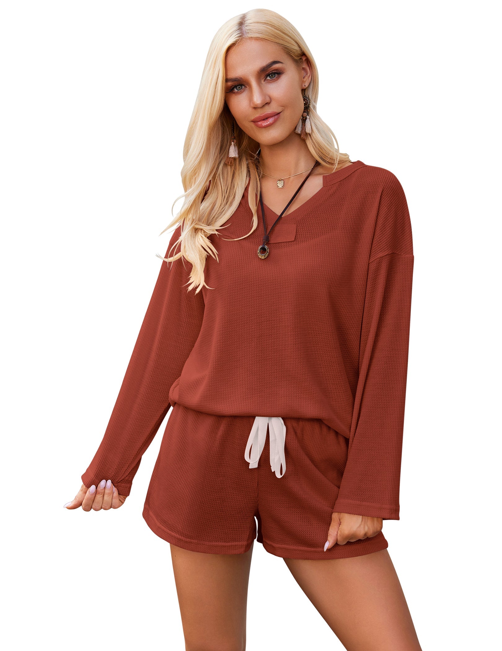 Orange-red knit long-sleeve pajama set with hooded neckline and drawstring shorts