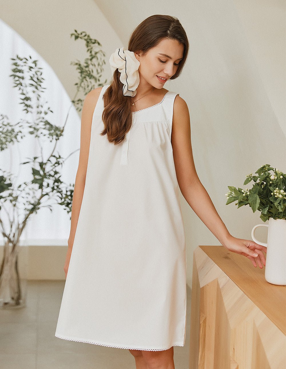 White lace-trim nightdress with ruffled cap sleeves, scoop neckline, gathered front