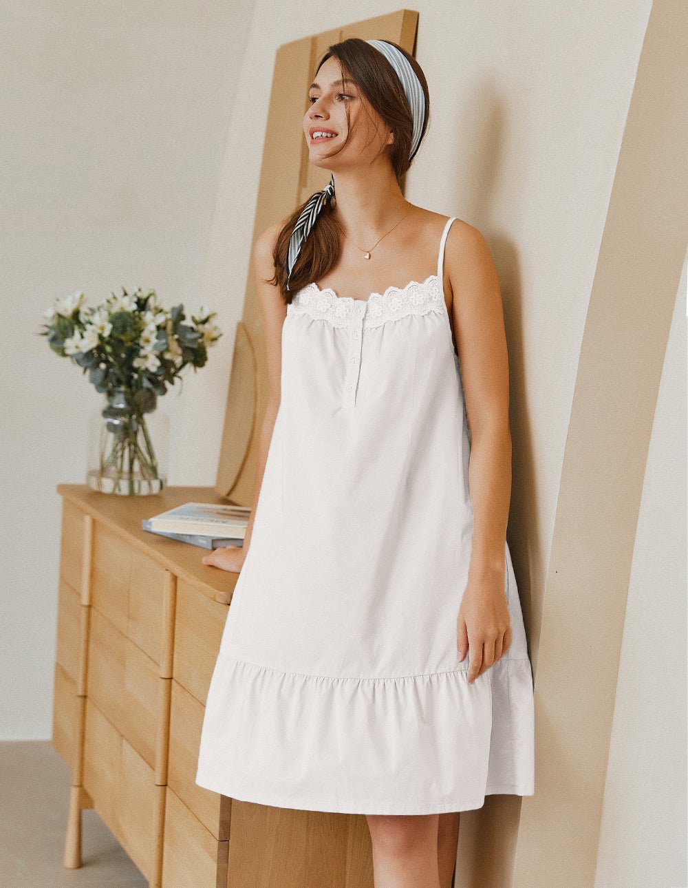 White lace-trim pajama dress with sleeveless straps, button front, and ruffle hem