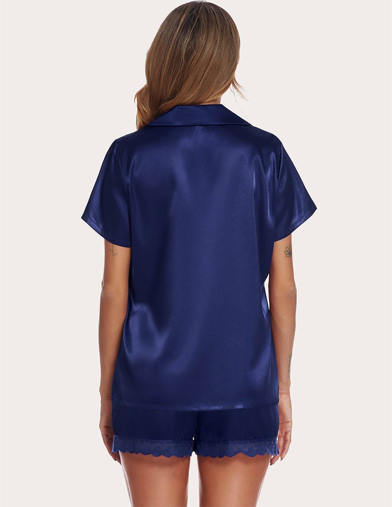 Navy satin pajama set, back view: short-sleeve button blouse with lace-trim shorts