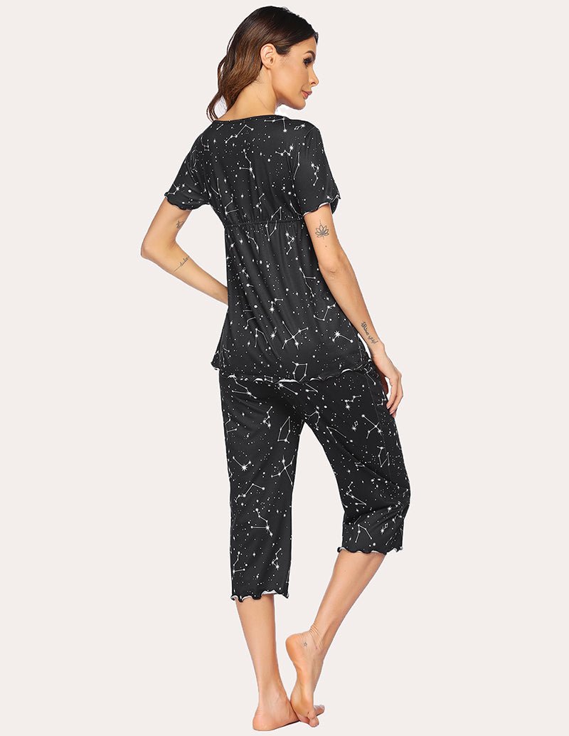 Maternity nursing pajama set in black with white star-like print, short-sleeve top and capri pants