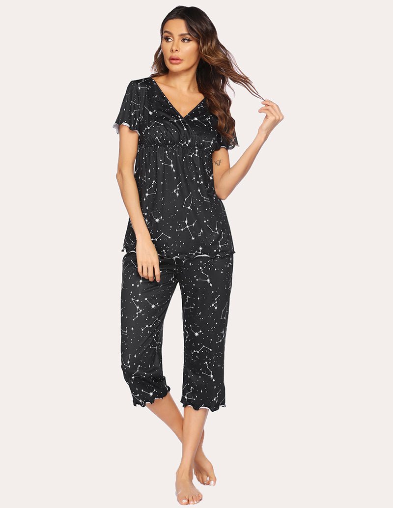 Maternity nursing pajama set in black with white star-like print, V-neck top and cropped capri legs