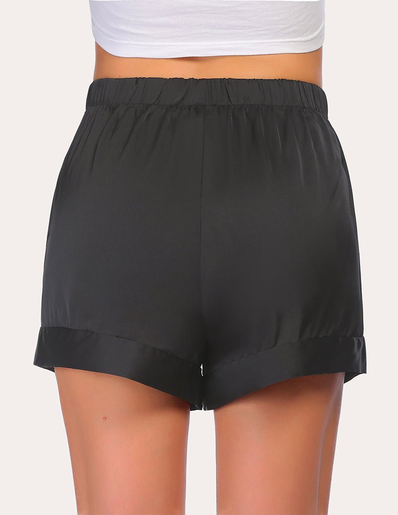 Black pajama shorts with elastic waist and relaxed fit, front view