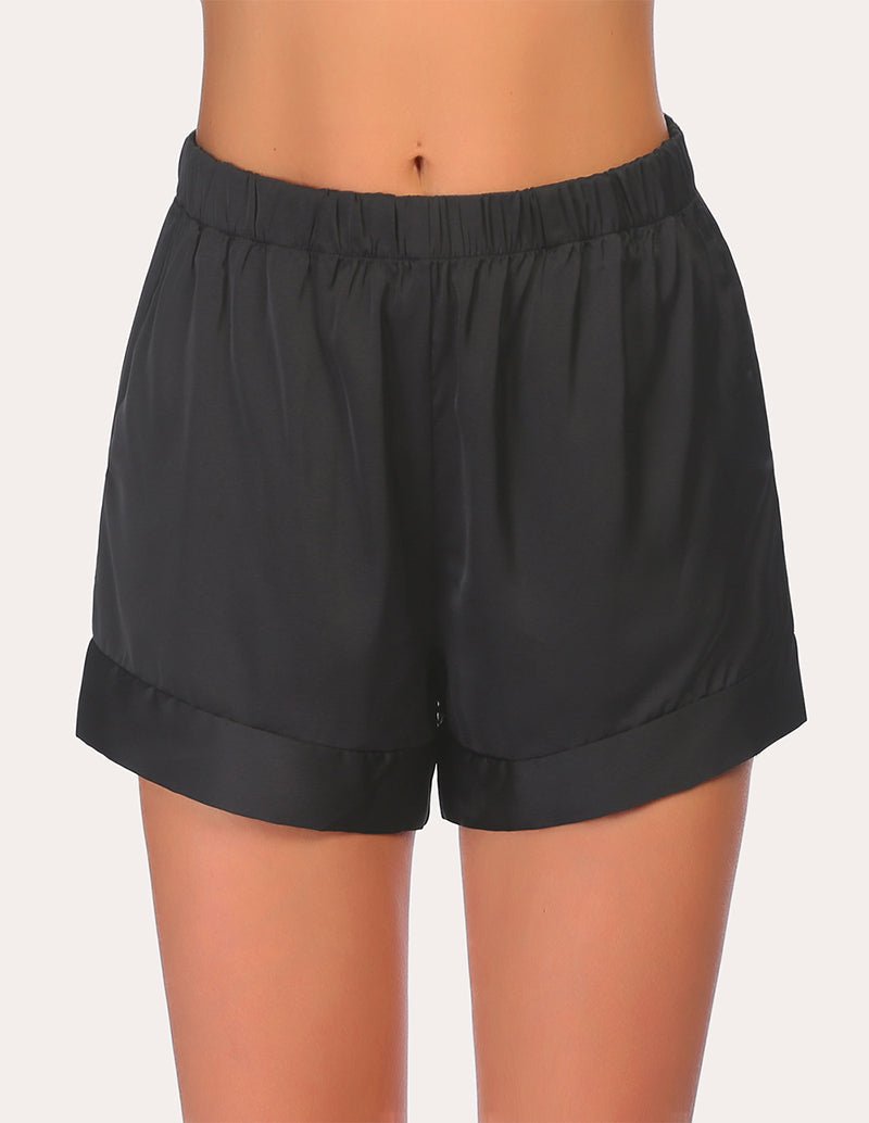 Black loose pajama shorts with elastic waistband and side pockets