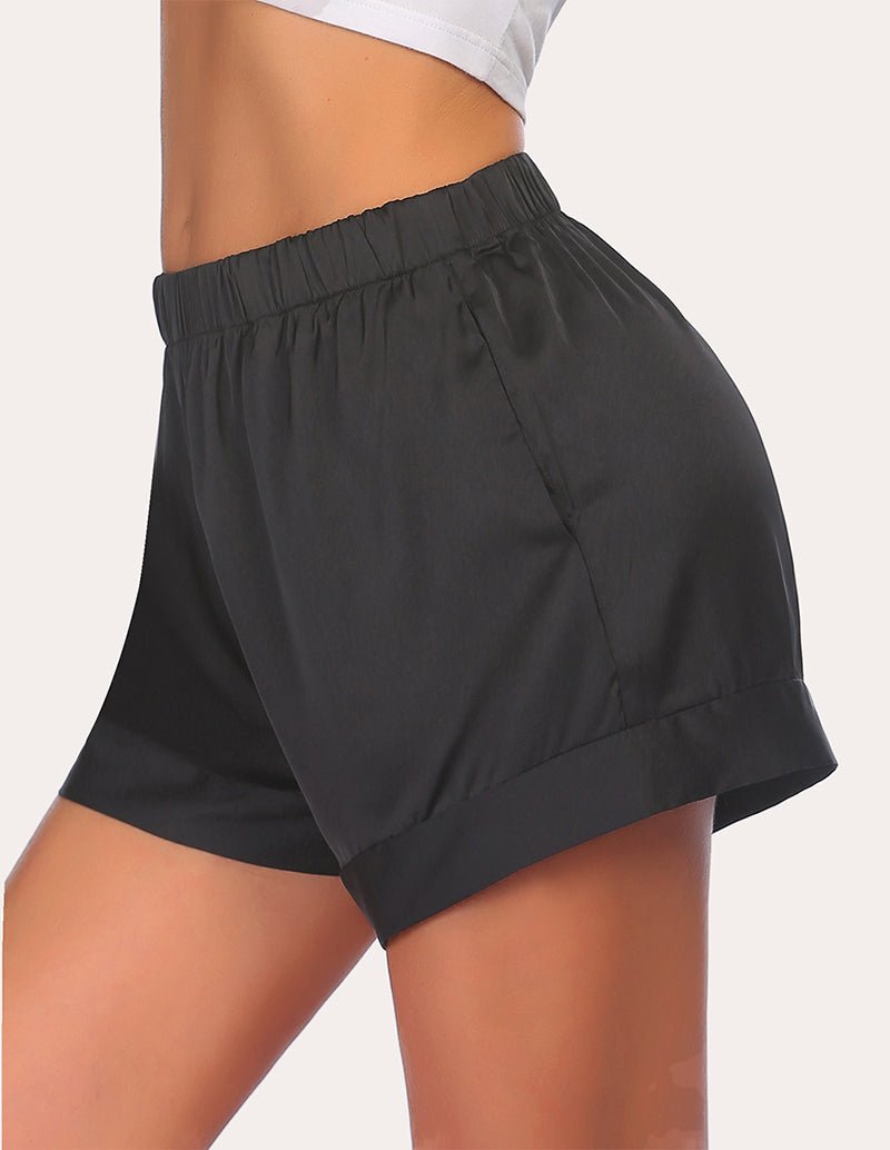 Black loose pajama shorts with elastic waistband and tapered side view