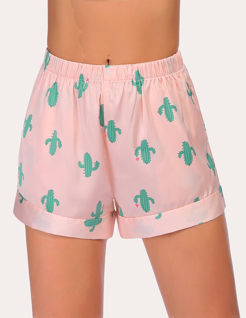 Loose pajama shorts in light pink with green cactus print and elastic waistband.